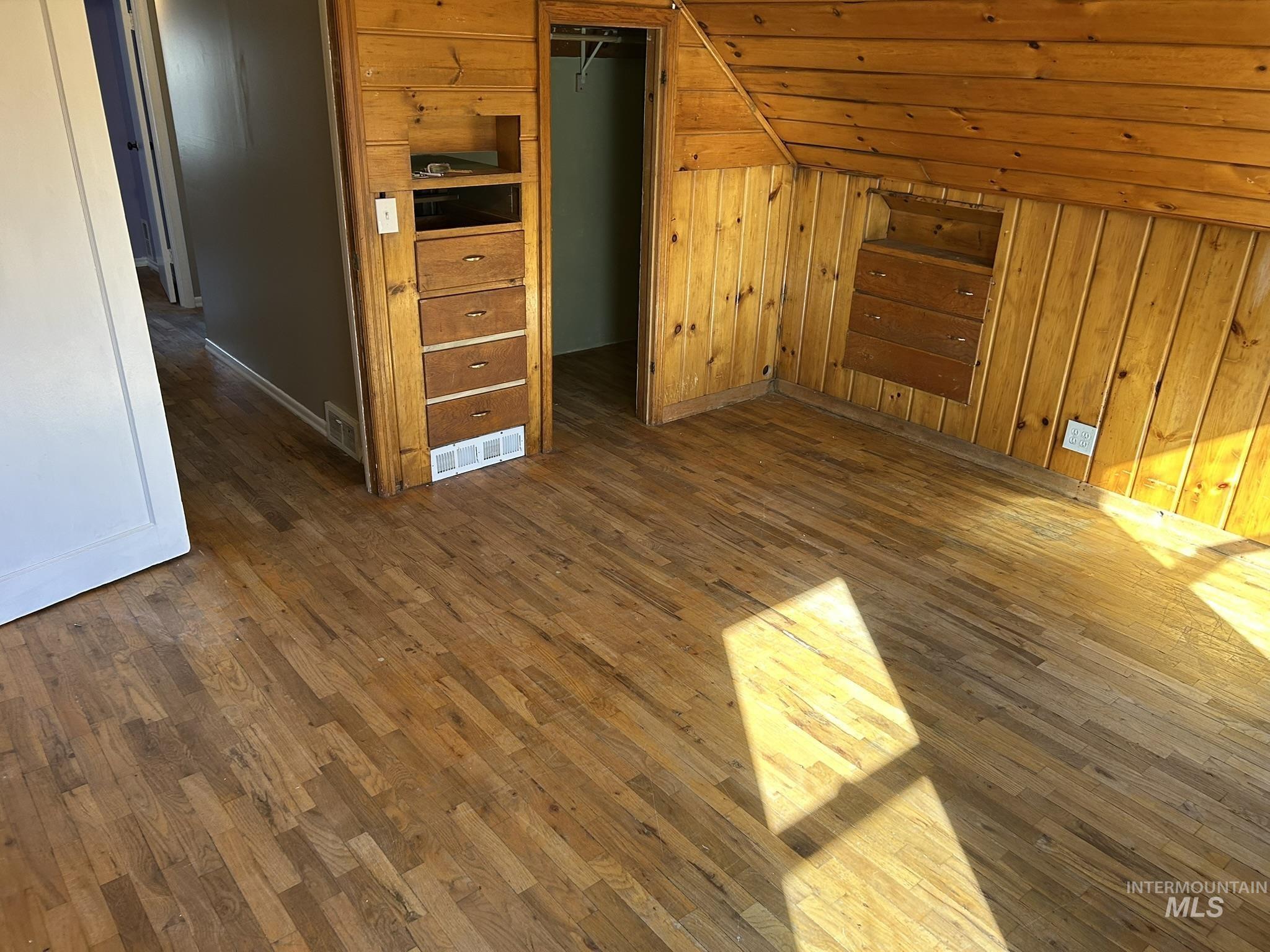 3837 16th Street Lewiston, ID 83501 - Photo 18 of 42 Additional living space featuring dark wood-style flooring, lofted ceiling, and wooden walls
