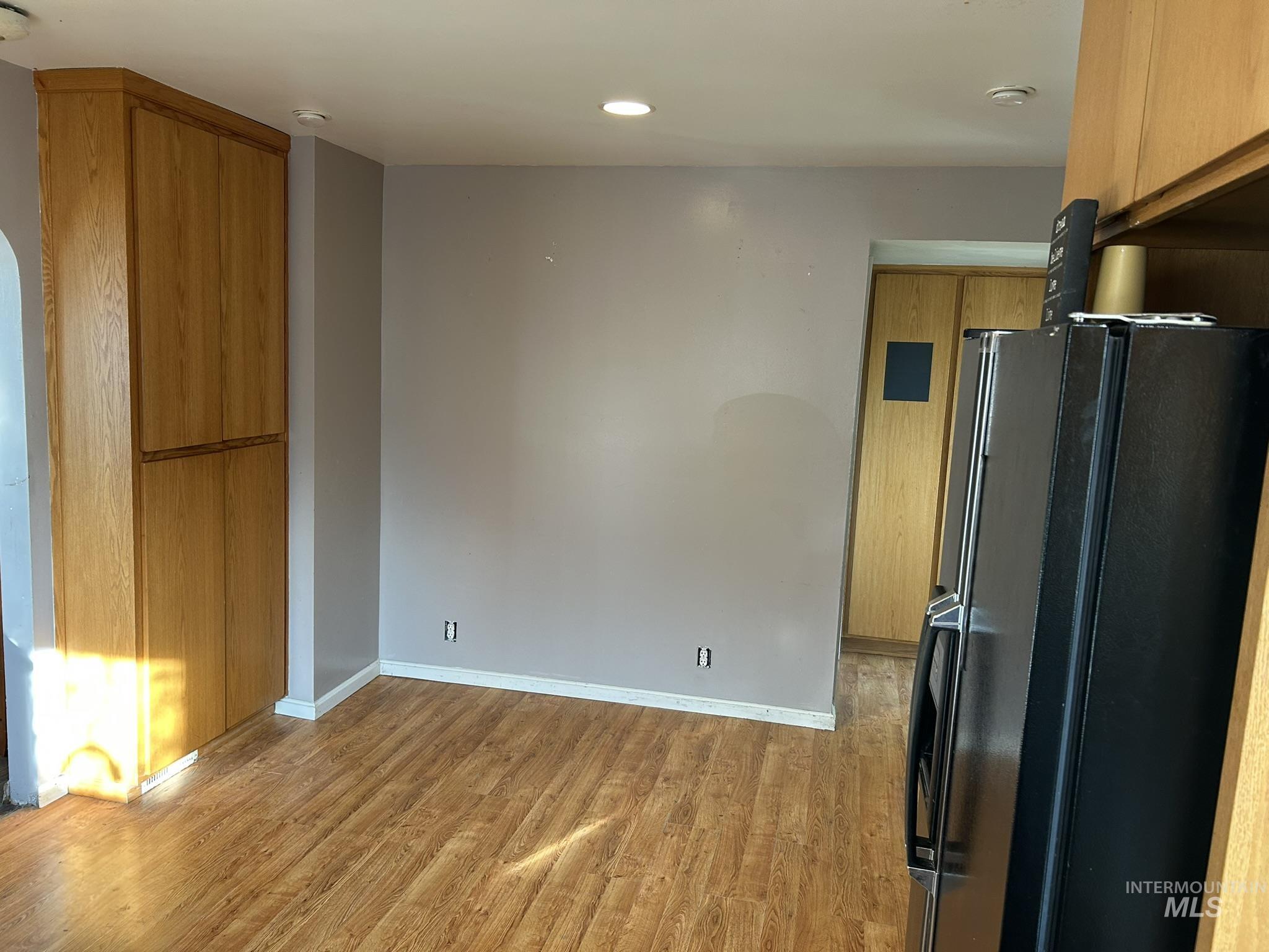 3837 16th Street Lewiston, ID 83501 - Photo 18 of 45 Kitchen with freestanding refrigerator, light wood-style flooring, brown cabinetry, modern cabinets, and recessed lighting
