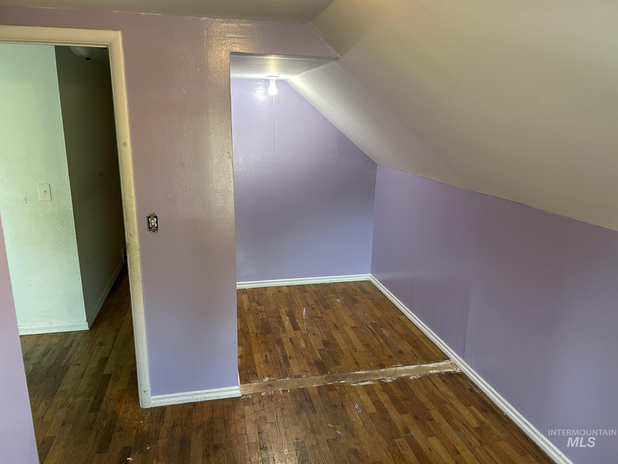 3837 16th Street Lewiston, ID 83501 - Photo 32 of 45 Additional living space with vaulted ceiling and dark wood-type flooring