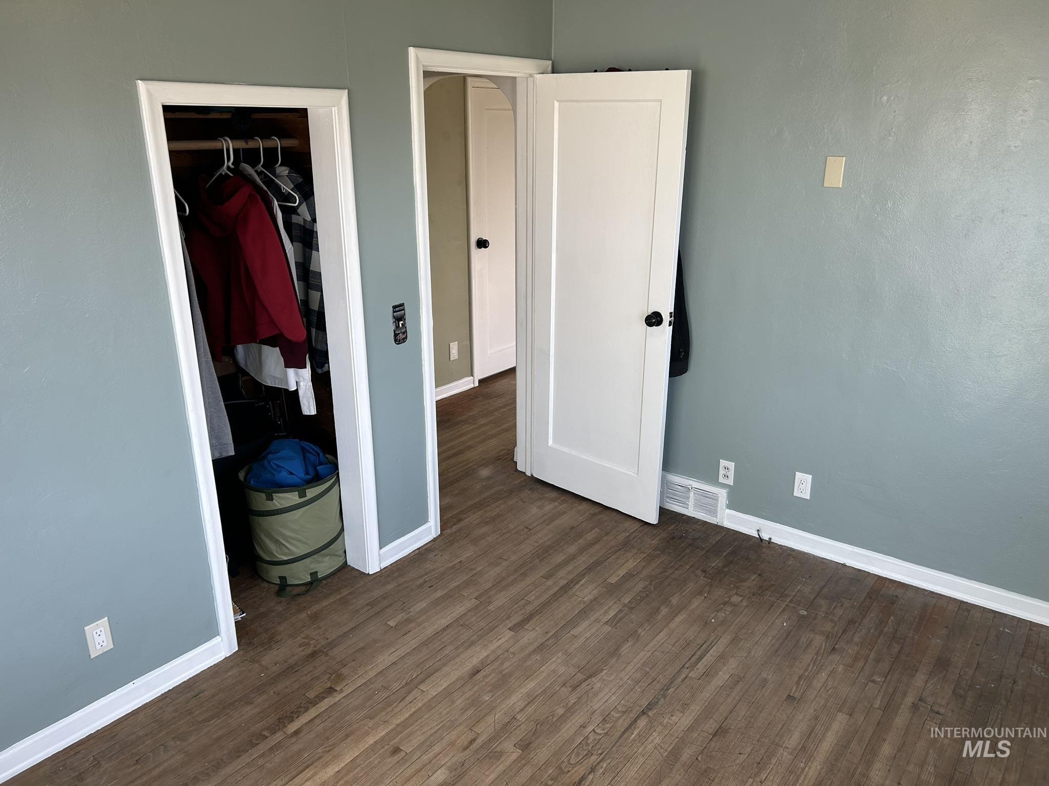 3837 16th Street Lewiston, ID 83501 - Photo 5 of 42 Unfurnished bedroom with baseboards and dark wood-style flooring