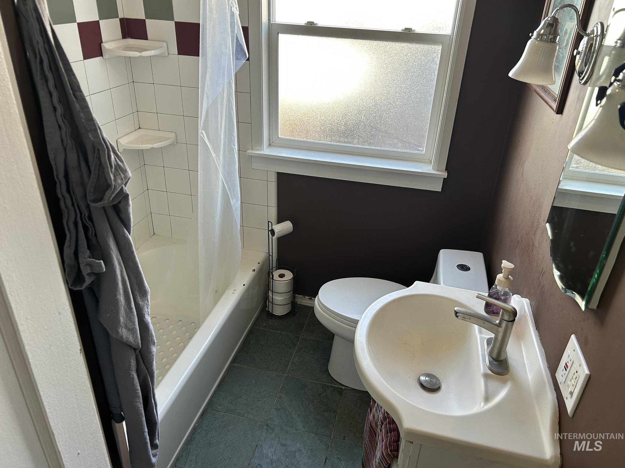 3837 16th Street Lewiston, ID 83501 - Photo 6 of 42 Full bath featuring vanity, dark tile patterned floors, and shower / tub combo