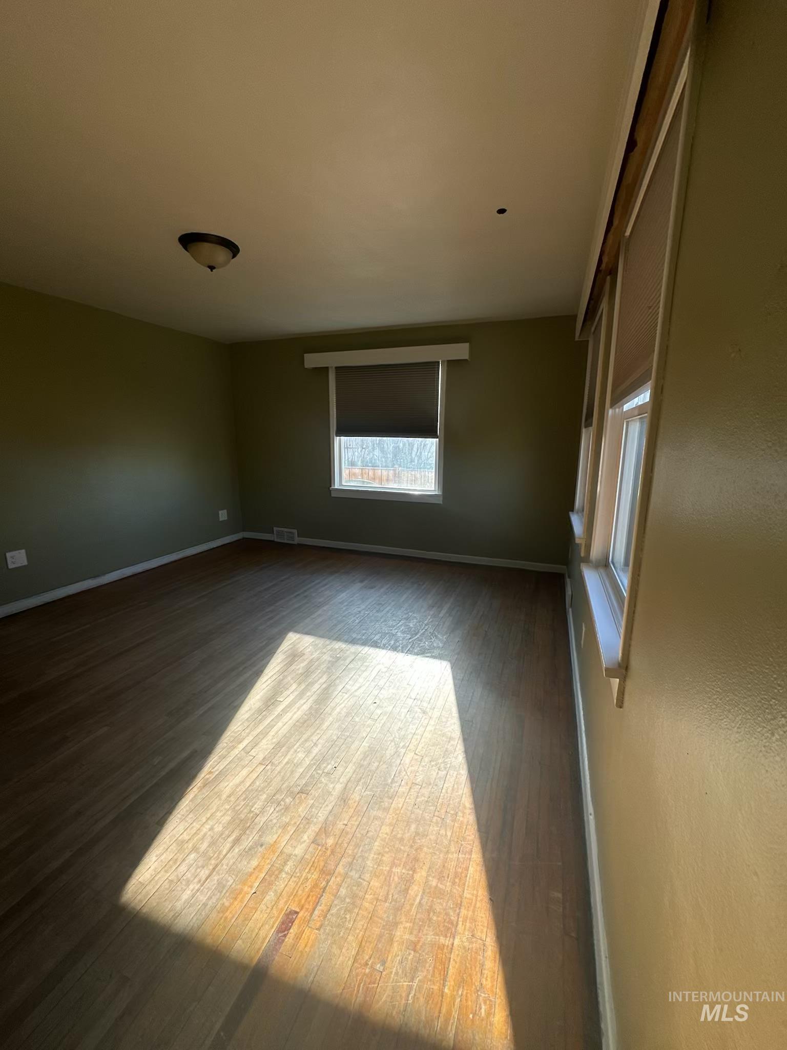 3837 16th Street Lewiston, ID 83501 - Photo 9 of 45 Empty room with dark wood-style flooring and baseboards