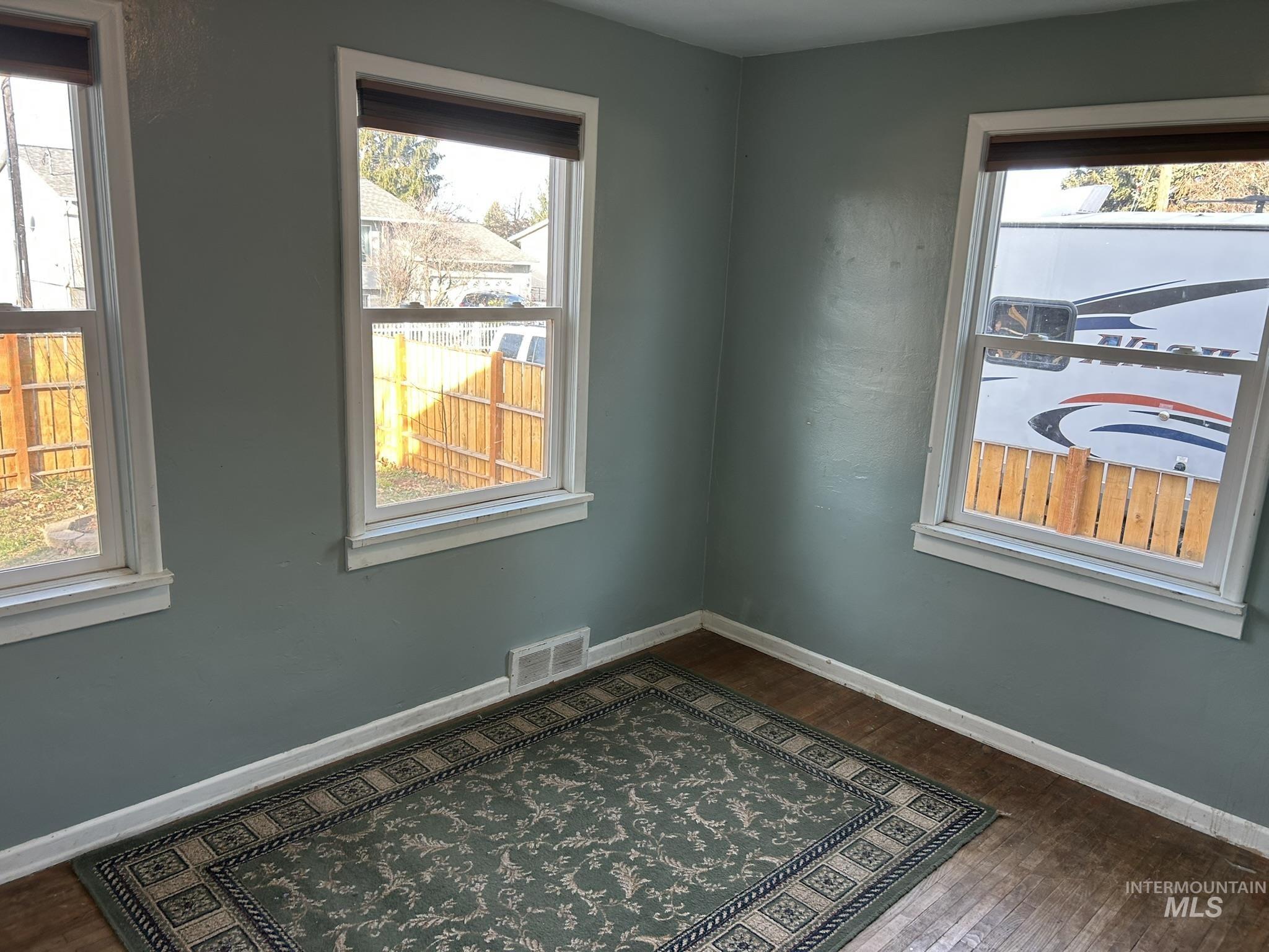 3837 16th Street Lewiston, ID 83501 - Photo 10 of 45 Spare room with baseboards and dark wood-type flooring