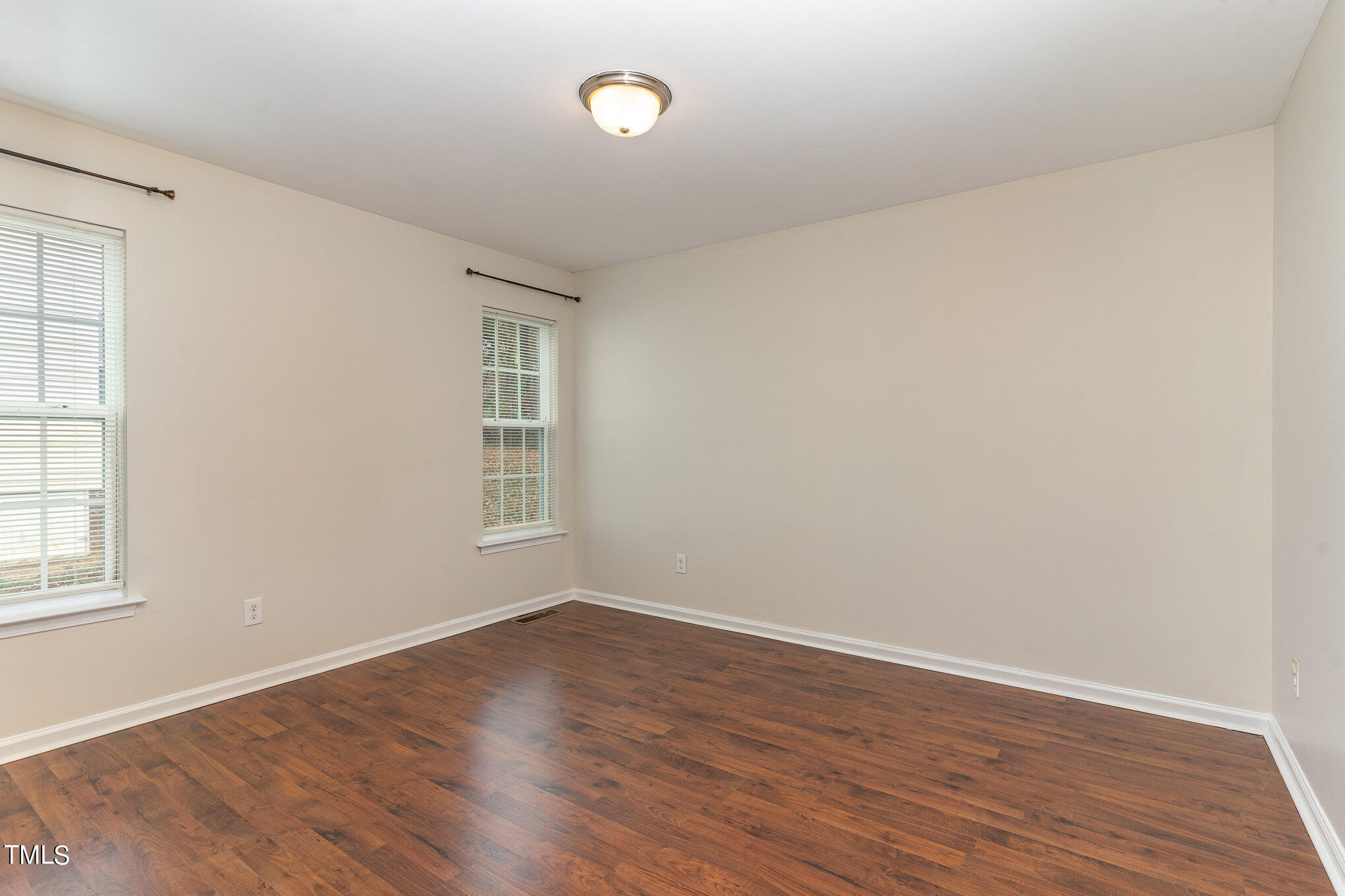 607 2nd Street Apex, NC 27502 - Photo 12 of 16 wooden floor in an empty room with a window
