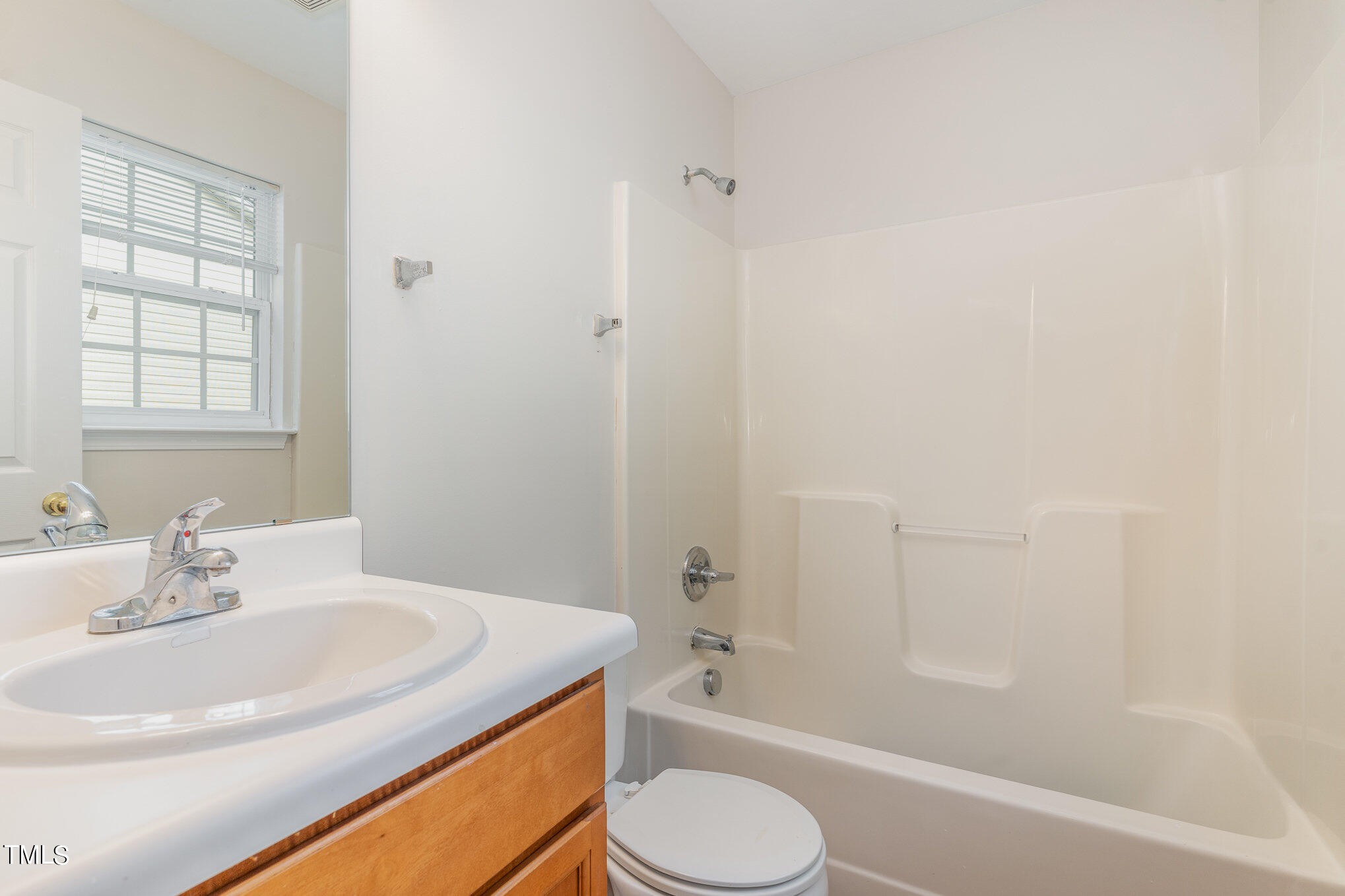 607 2nd Street Apex, NC 27502 - Photo 14 of 16 a bathroom with a sink toilet and a bathtub