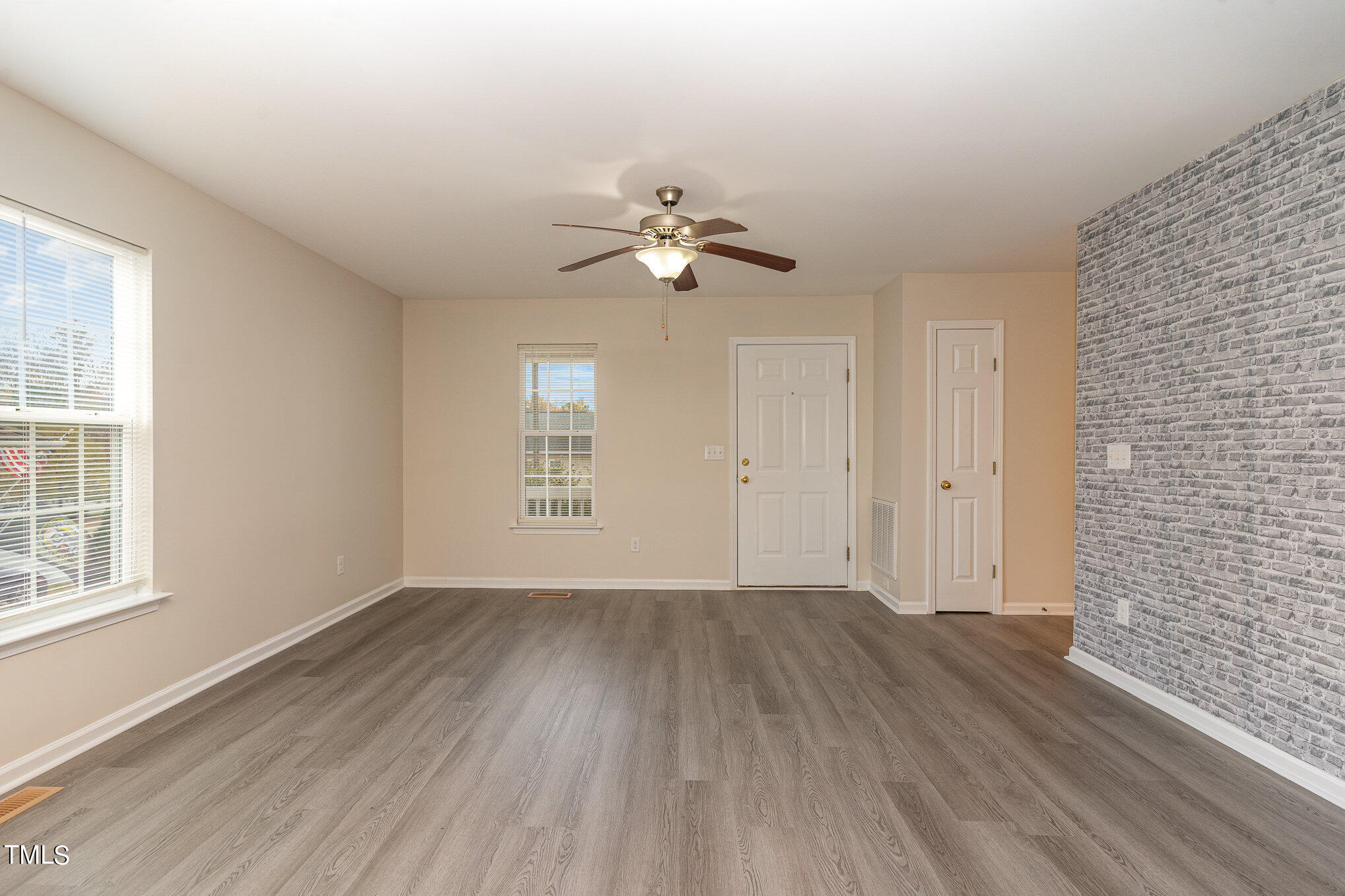 607 2nd Street Apex, NC 27502 - Photo 4 of 16 wooden floor in an empty room with a window