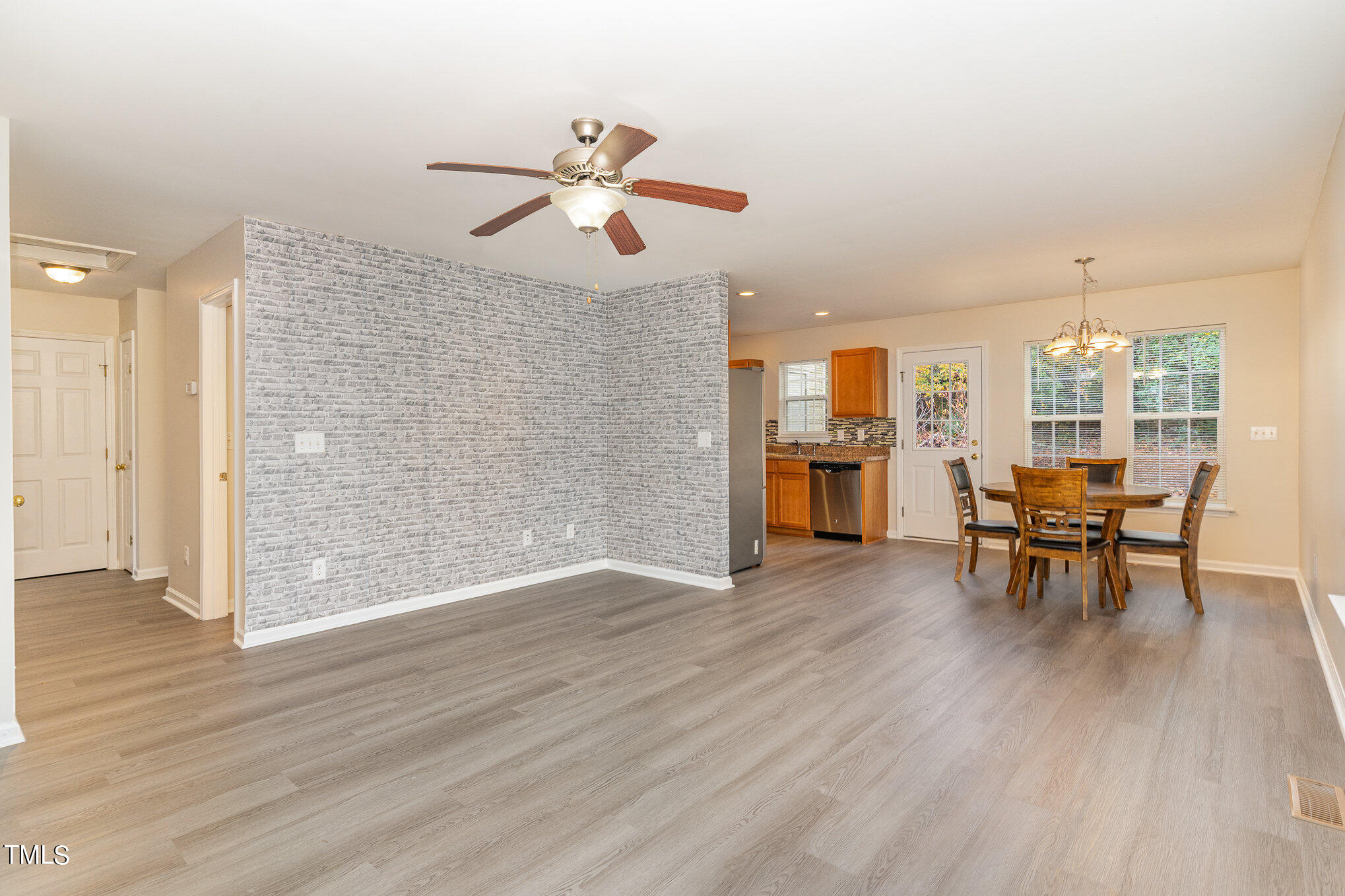 607 2nd Street Apex, NC 27502 - Photo 5 of 16 an empty room with wooden floor and way to kitchen