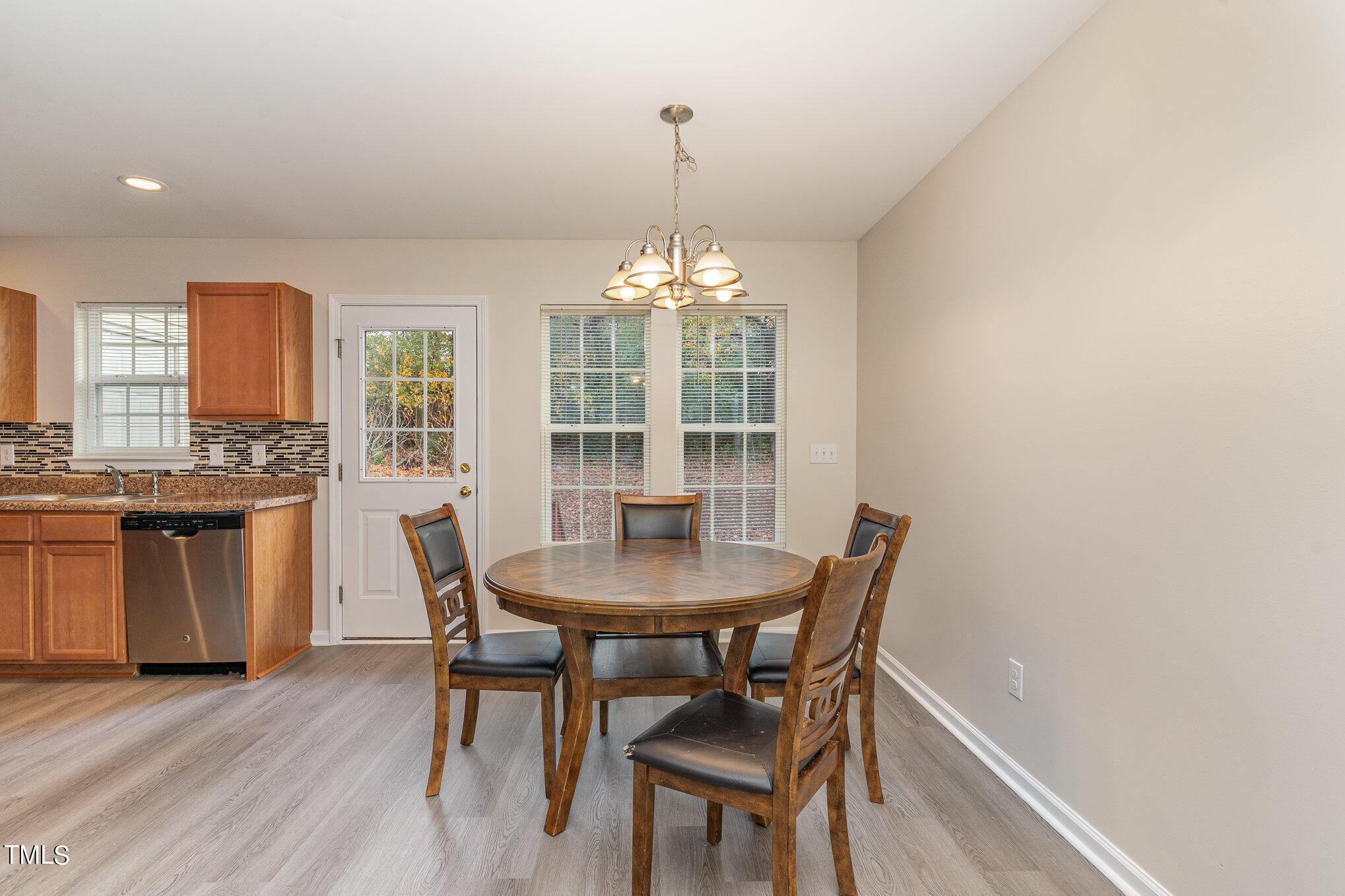 607 2nd Street Apex, NC 27502 - Photo 6 of 16 a view of a dining room with furniture window and wooden floor