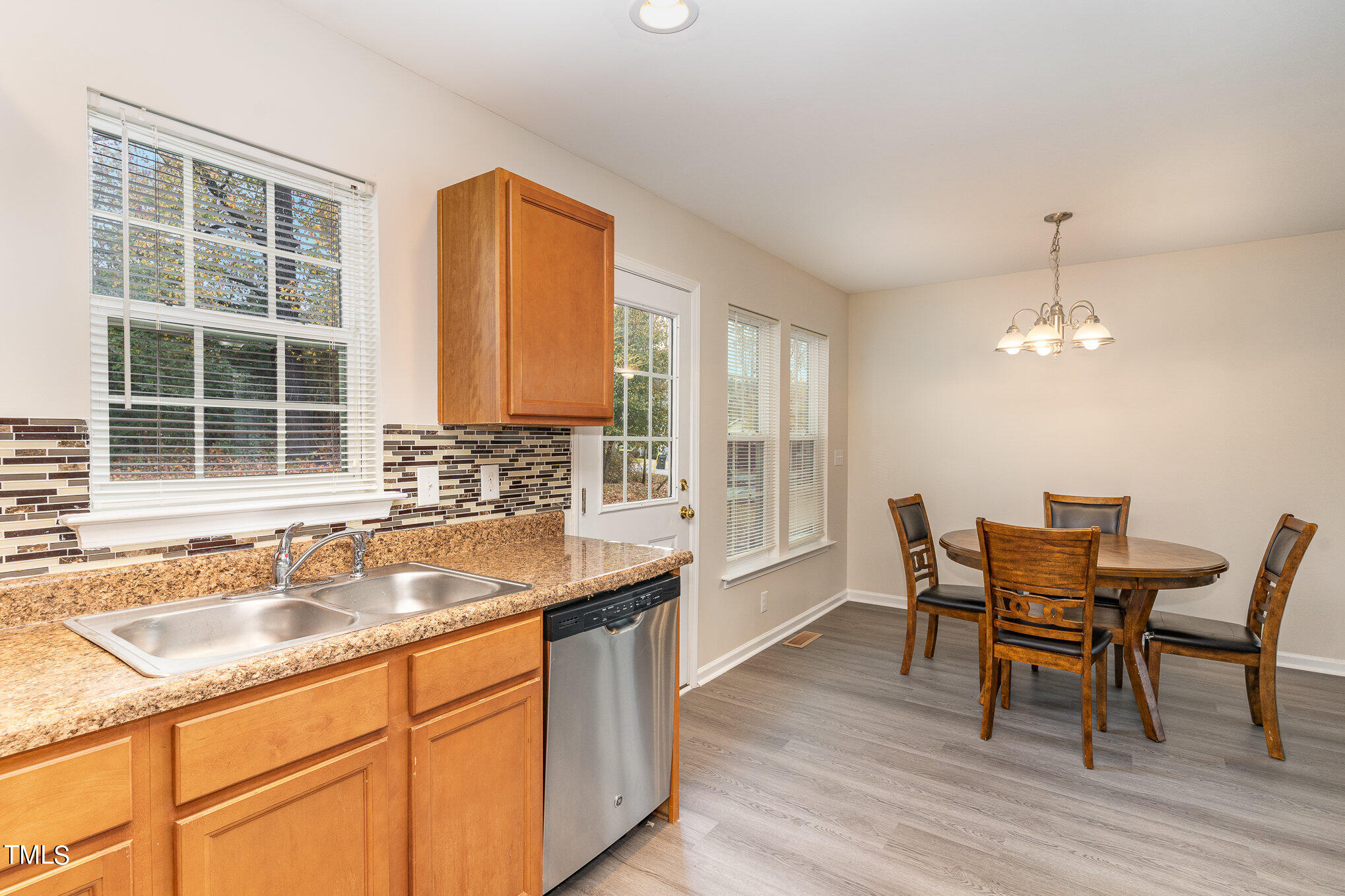607 2nd Street Apex, NC 27502 - Photo 8 of 16 a kitchen with a sink cabinets dining table and chairs