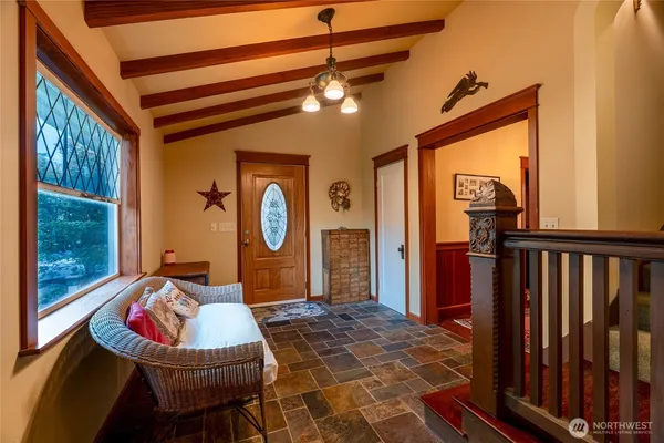 a living room with furniture a rug and a chandelier