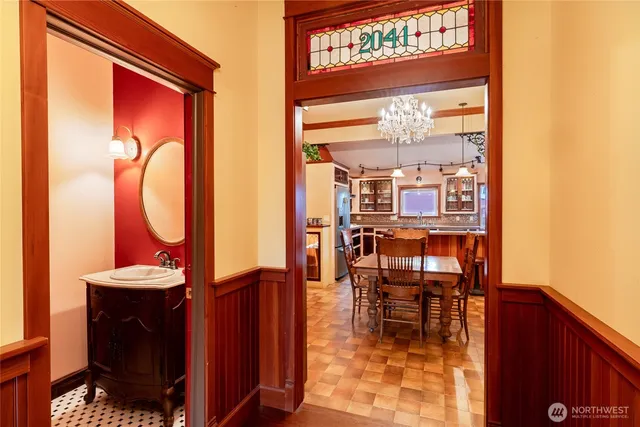 a dining room with furniture and a floor to ceiling window