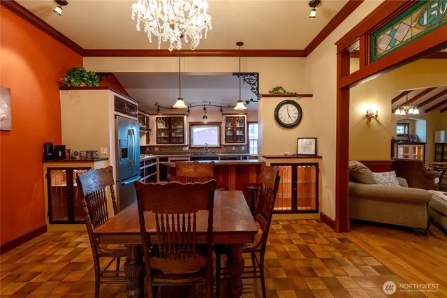 a view of a dining room with furniture and a chandelier