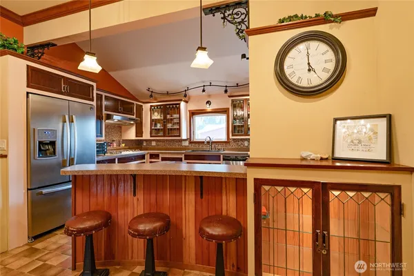 a view of a kitchen with a sink and a refrigerator