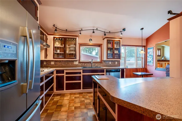 a kitchen with stainless steel appliances a stove and more cabinets