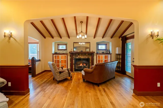 a living room with furniture a flat screen tv and a table