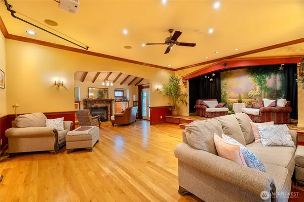 an empty room with windows & ceiling fan