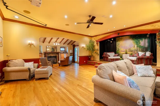 an empty room with windows & ceiling fan