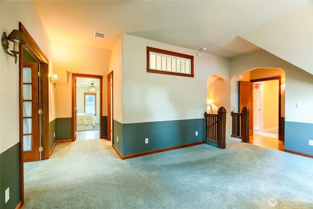a bathroom with double vanity and a mirror