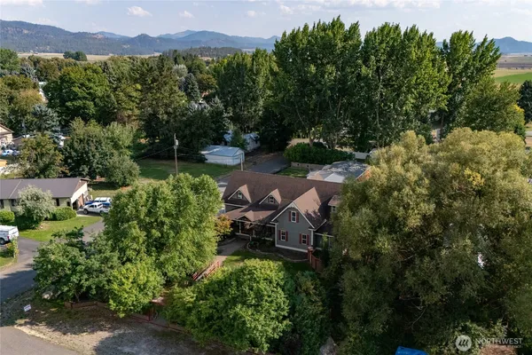 an aerial view of a house with a yard and lake view