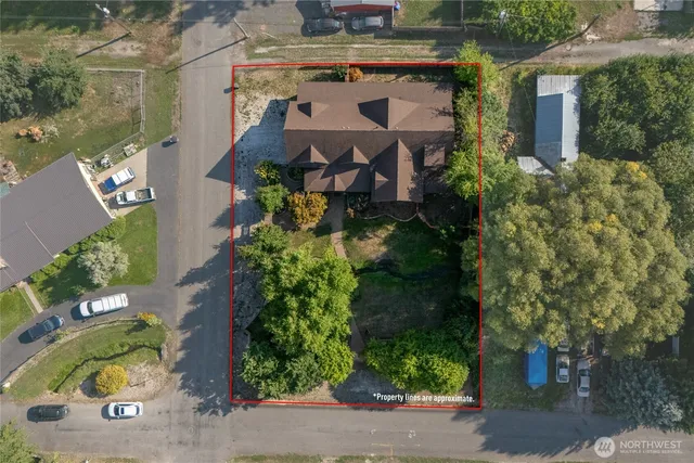 an aerial view of a house with garden space and street view