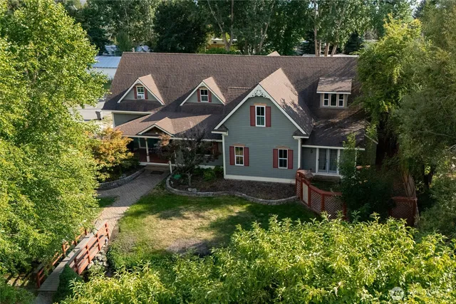 a aerial view of a house with a yard table and chairs