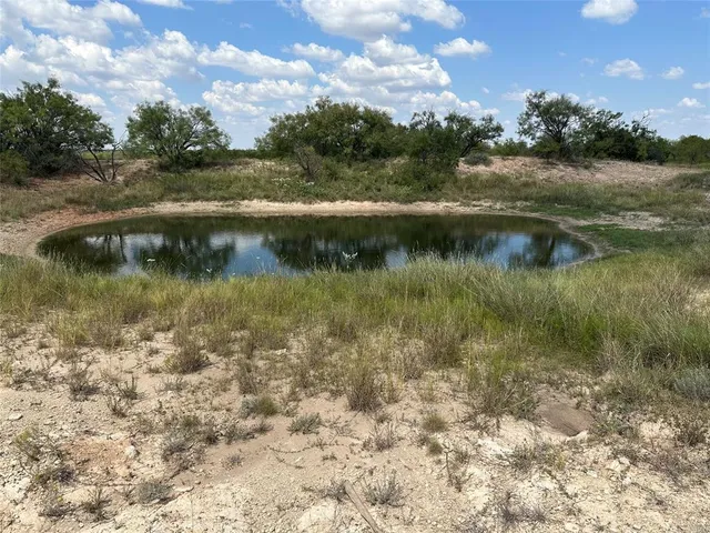 a view of a lake with houses in the back