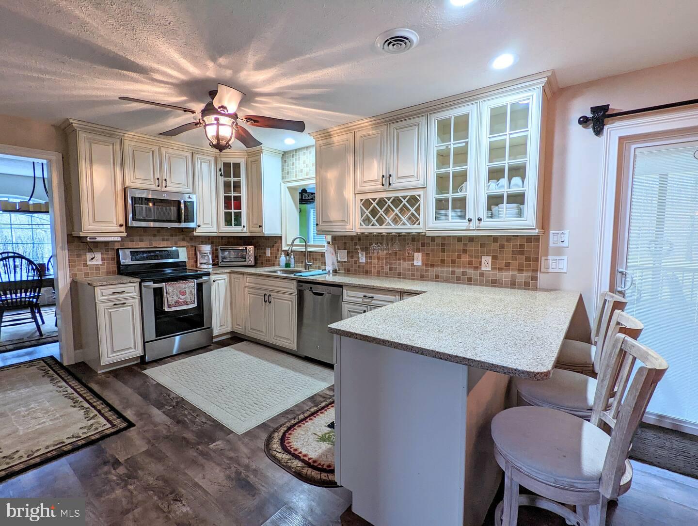 14 Minnie Ha-Ha Road Albrightsville, PA 18210 - Photo 13 of 34 a kitchen with a stove a sink a dining table and chairs