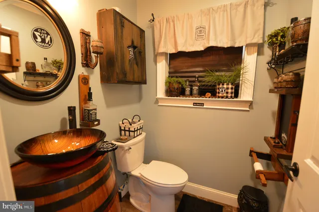 a bathroom with a toilet and a mirror