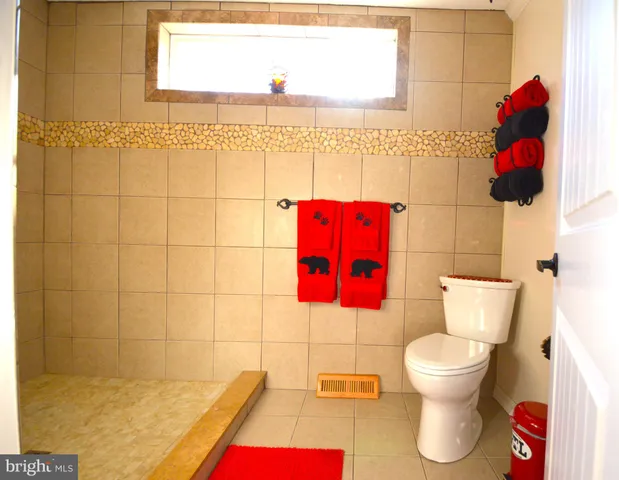 a bathroom with a toilet and a shower curtain