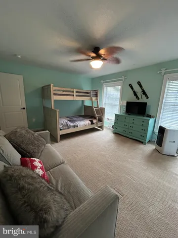 a bathroom with a granite countertop toilet sink and mirror