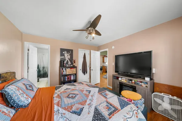 a bedroom with a bed and a flat screen tv