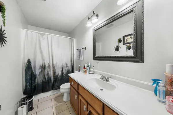 a bathroom with a sink mirror and a toilet