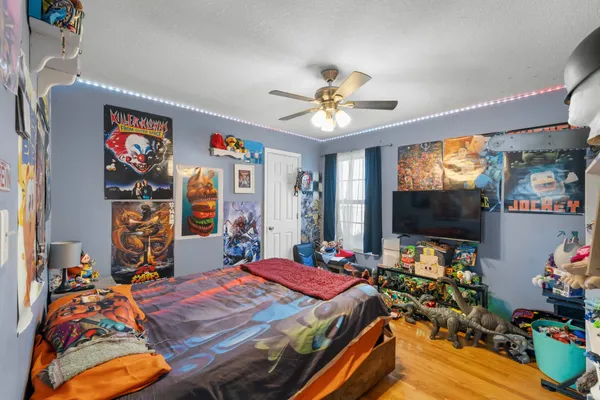 a bedroom with a bed and a flat screen tv