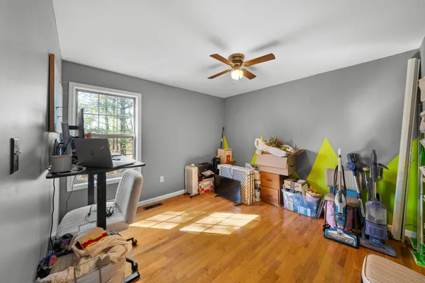 a view of a workspace with furniture and a window