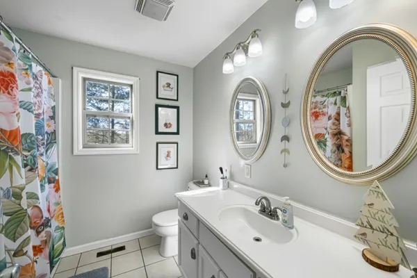 a bathroom with double vanity sinks and a mirror