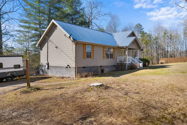 a view of a house with a yard covered in snow