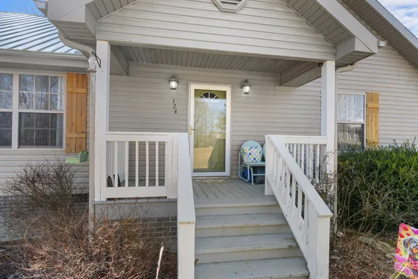 a view of a house with backyard and porch