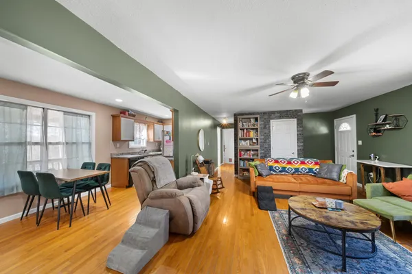 a living room with furniture dining table and a large window