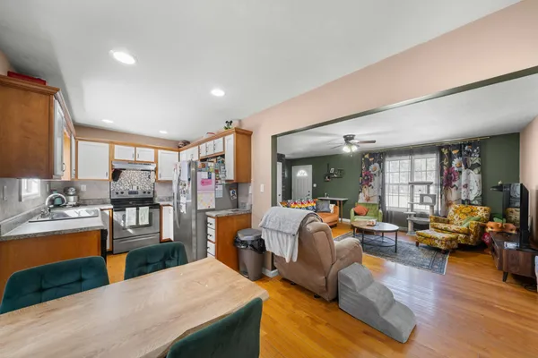 a living room with fireplace furniture and a large window