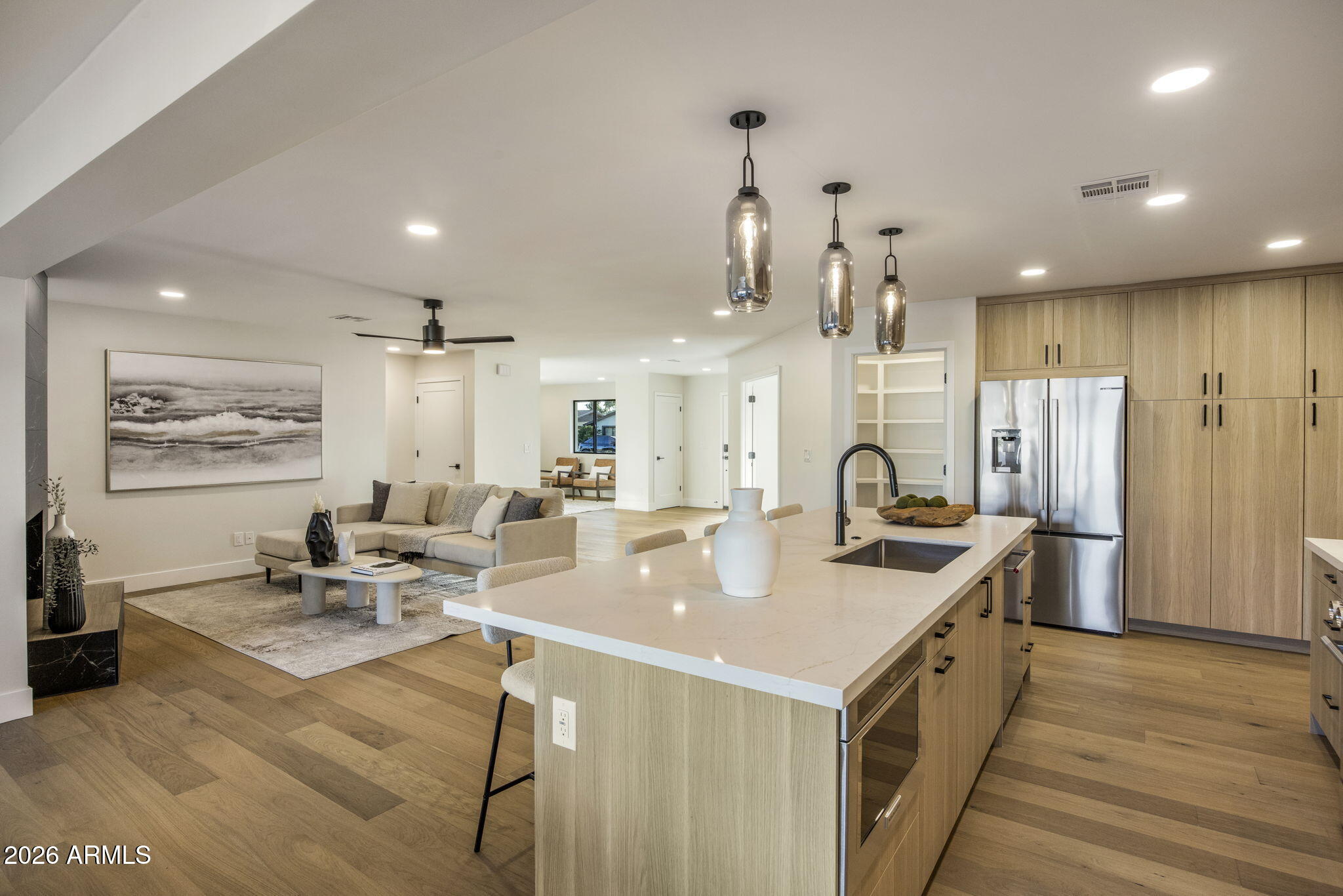 3023 North 49th Street Phoenix, AZ 85018 - Photo 11 of 32 a open kitchen with stainless steel appliances granite countertop a sink dishwasher a refrigerator and a dining table with wooden floor