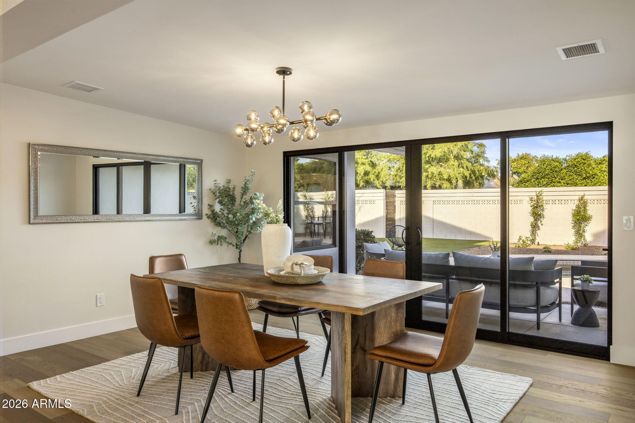 3023 North 49th Street Phoenix, AZ 85018 - Photo 12 of 32 a view of a dining room with furniture window and wooden floor