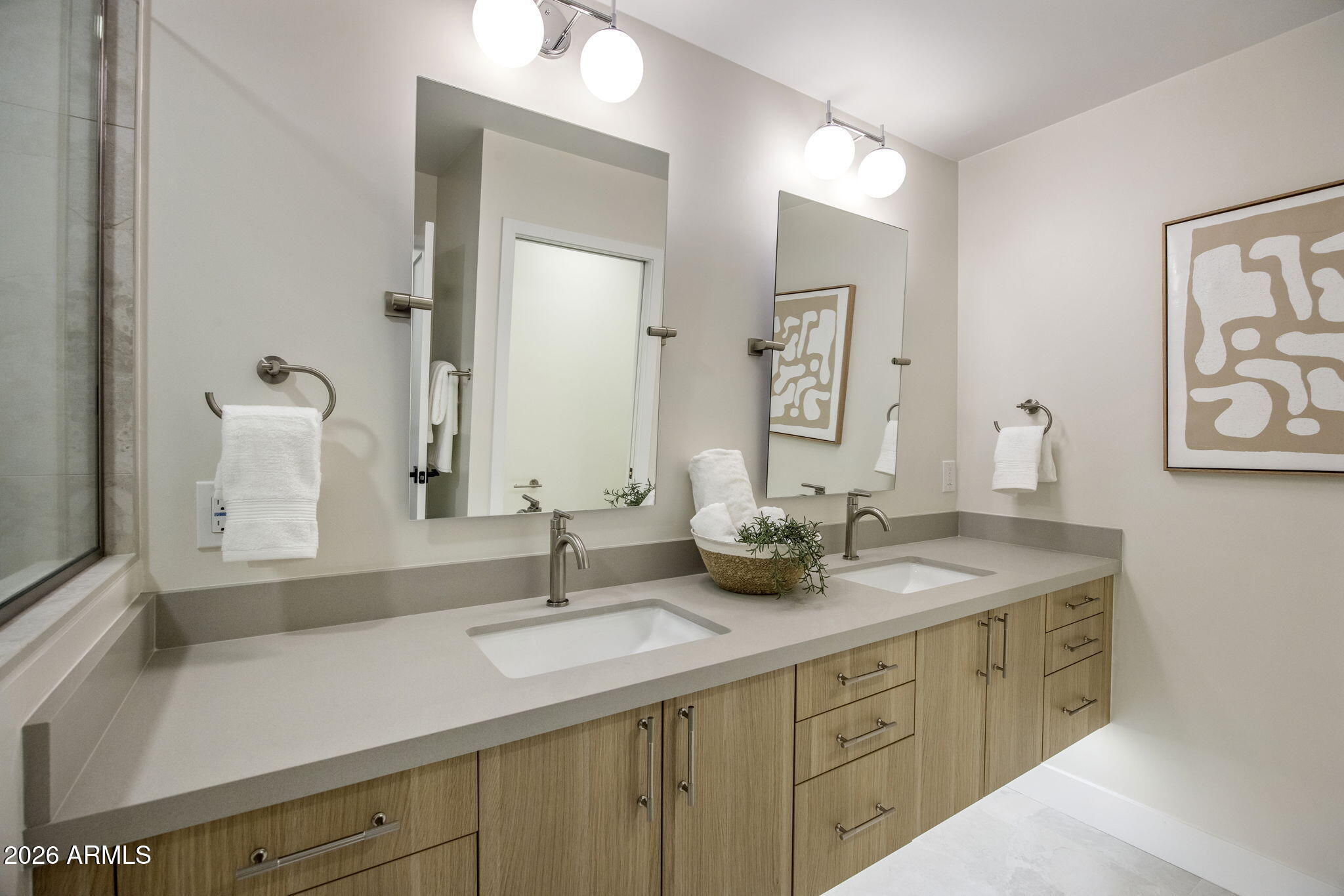 3023 North 49th Street Phoenix, AZ 85018 - Photo 18 of 32 a bathroom with double sink and a mirror