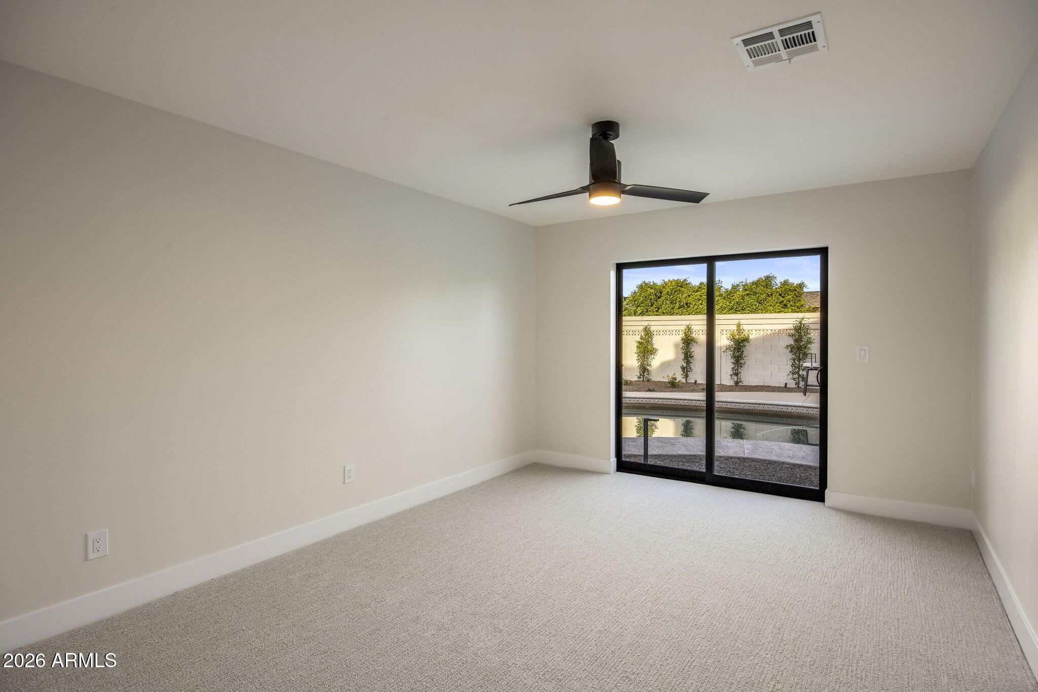 3023 North 49th Street Phoenix, AZ 85018 - Photo 19 of 32 an empty room with windows and ceiling fan