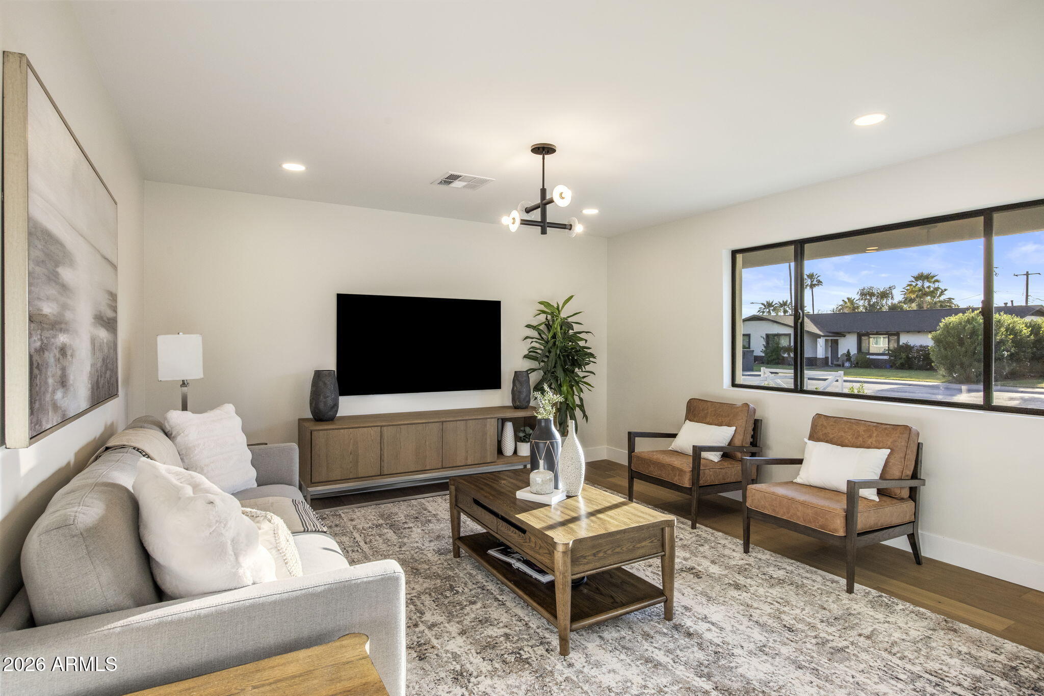 3023 North 49th Street Phoenix, AZ 85018 - Photo 4 of 32 a living room with furniture and a flat screen tv