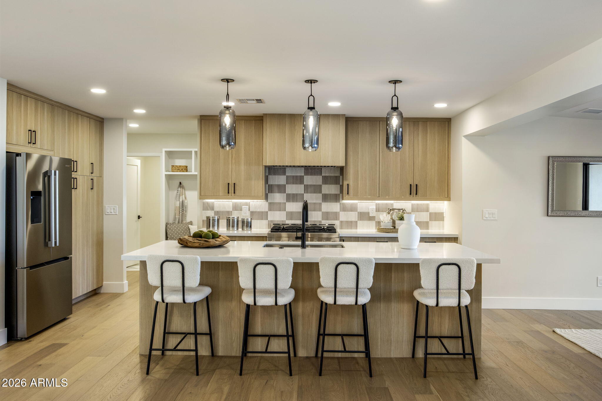 3023 North 49th Street Phoenix, AZ 85018 - Photo 9 of 32 a kitchen with kitchen island wooden cabinets and stainless steel appliances