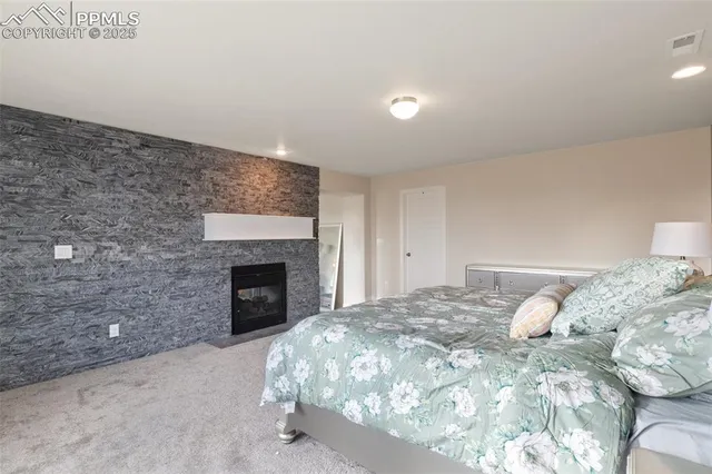 a bedroom with a bed and a fireplace