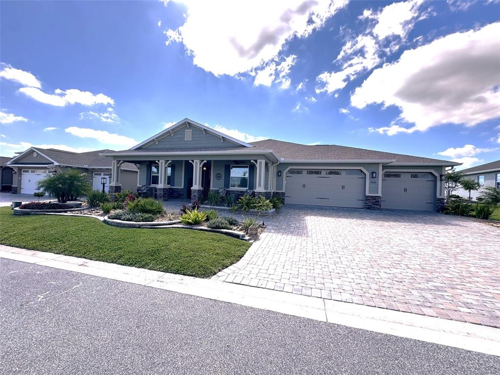 9232 Southwest 85th Place Ocala, FL 34481 - Photo 1 of 38 a front view of a house with a yard and garage