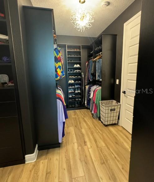 9232 Southwest 85th Place Ocala, FL 34481 - Photo 16 of 38 a view of walk in closet with clothes