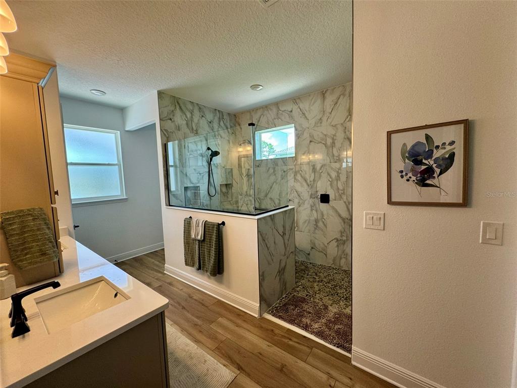 9232 Southwest 85th Place Ocala, FL 34481 - Photo 18 of 38 a bathroom with a sink mirror and a shower