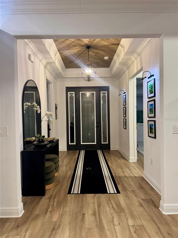 9232 Southwest 85th Place Ocala, FL 34481 - Photo 4 of 38 a view of a hallway with wooden floor and furniture